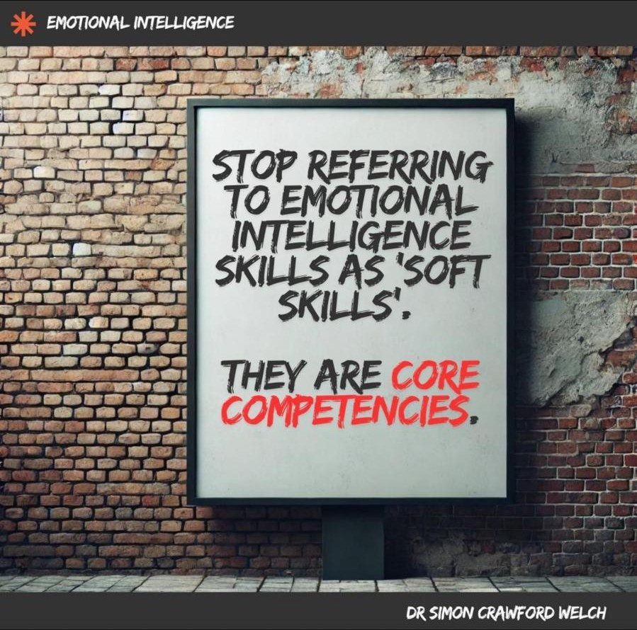 Poster by Dr. Simon Crawford Welch: a poster on a brick wall saying emotional intelligence skills are core competencies, not soft skills.